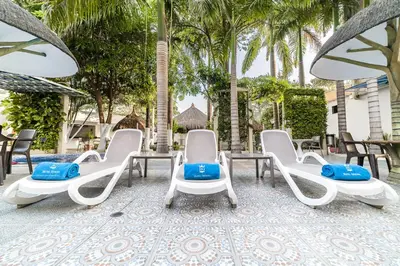 a group of chairs and tables on a patio at Hotel Genova Centro in Barranquilla
