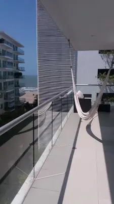 a hammock on a balcony with a view of the ocean at Cartagena Beach Condo - 1400 sq. Ft. (130 m2) in Cartagena de Indias