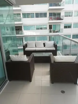 a balcony with two wicker chairs and a building at Cartagena Beach Condo - 1400 sq. Ft. (130 m2) in Cartagena de Indias