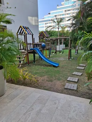 a playground with a slide and a swing set at Cartagena Beach Condo - 1400 sq. Ft. (130 m2) in Cartagena de Indias