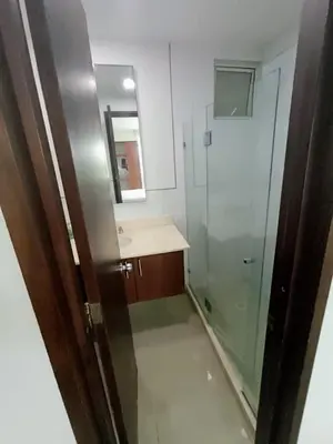 a bathroom with a shower and a sink and a mirror at Edificio acceso directo al mar primera linea de playa 2 habitaciones in Cartagena de Indias
