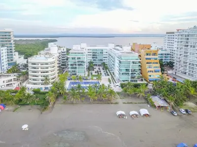 an aerial view of a beach with buildings and umbrellas at Edificio acceso directo al mar primera linea de playa 2 habitaciones in Cartagena de Indias