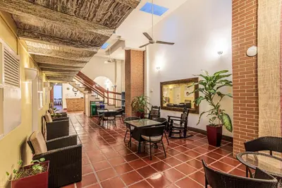 a lobby with tables and chairs in a building at Hotel El Viajero Centro in Cartagena de Indias