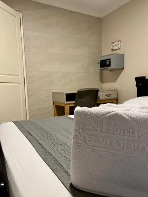 a hotel room with a bed and a desk and a desk at Hotel El Viajero Centro in Cartagena de Indias