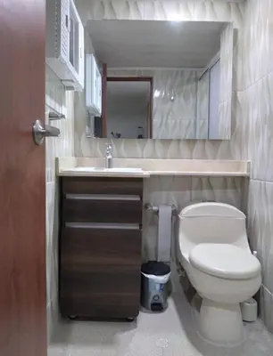 a small bathroom with a toilet and a sink at Apartamento 1101 Edificio Nuevo Conquistador in Cartagena de Indias
