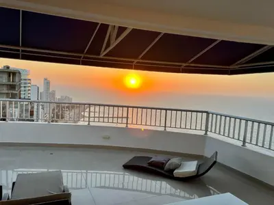 a living room with a view of the ocean at Palmetto Penthouse Deluxe Beautiful view and sunset floor 39 in Cartagena de Indias