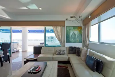 a living room with a couch and a table at Palmetto Penthouse Deluxe Beautiful view and sunset floor 39 in Cartagena de Indias