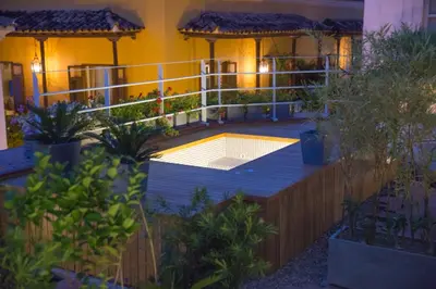 a house with a swimming pool in a garden at night at Hotel Boutique Casona del Colegio in Cartagena de Indias