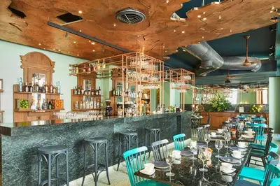 a restaurant with a bar with tables and chairs at Hotel Boutique Casona del Colegio in Cartagena de Indias