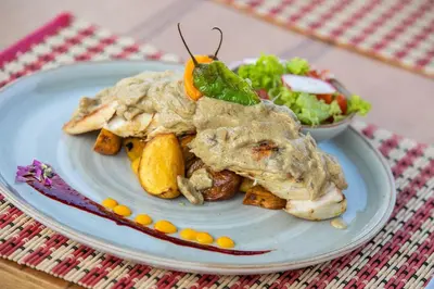 a plate of food on a table with a salad at Hotel Arena Beach Cartagena in Cartagena de Indias