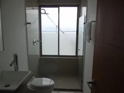 a bathroom with a toilet and a sink and a window at Mi Apartamento en Cartagena in Cartagena de Indias