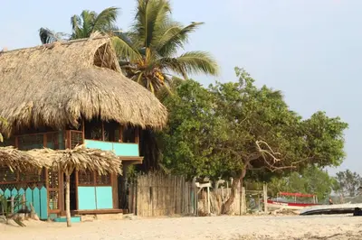 a hut with a straw roof on the beach at Casa Akira- Rincón del Mar in San Onofre