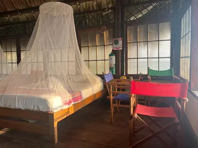 a bedroom with a bed and a table and chairs at Casa Akira- Rincón del Mar in San Onofre