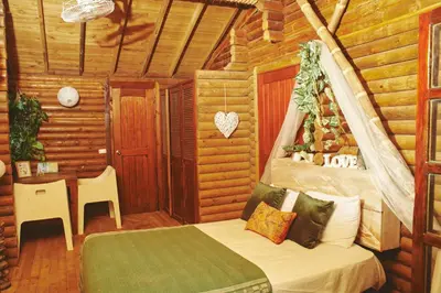 a bedroom with a bed in a log cabin at MISTICA Isla Palma in Isla Palma