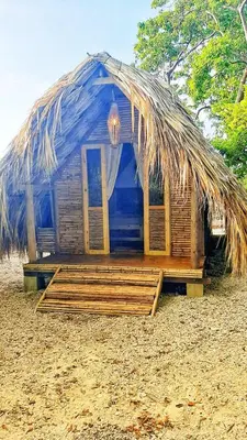a small hut with a thatched roof on a beach at MISTICA Isla Palma in Isla Palma