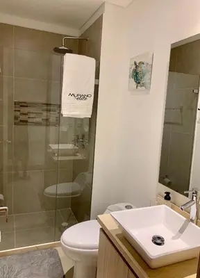 a bathroom with a toilet and a sink and a shower at MURANO ELITE NEW OCEAN FRONT DUPLEx in Cartagena de Indias