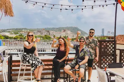 a group of people sitting on a balcony at Los Patios Hostel Cartagena in Cartagena de Indias