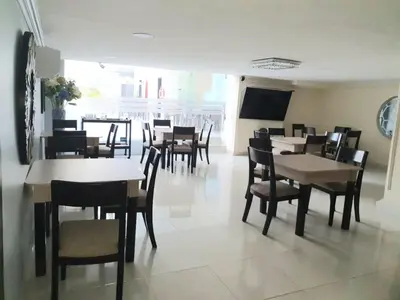a dining room with tables and chairs in a restaurant at Hotel Puerta de Oro in Barranquilla