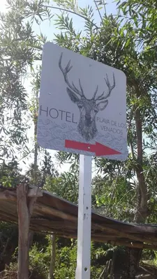 a sign for a hotel with a deer head on it at Cabaña Playa De Los Venados in San Bernardo del Viento