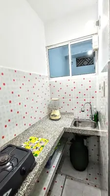 a small kitchen with a sink and a counter at Oasis de Tolú in Tolú
