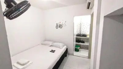 a small bedroom with a bed and a bike on the wall at Oasis de Tolú in Tolú