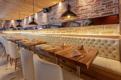 a row of tables and chairs in a restaurant at Hotel Santa Catalina By OxoHotel in Cartagena de Indias
