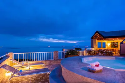 a villa with a swimming pool at night at Hotel Irotama XXI in Santa Marta