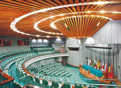 a large auditorium with green chairs and a large ceiling at Hotel Irotama Lago in Santa Marta