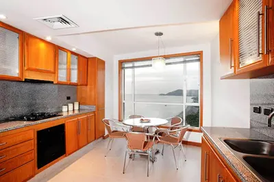 a kitchen with a table and chairs and a window at Hotel Irotama del Sol in Santa Marta