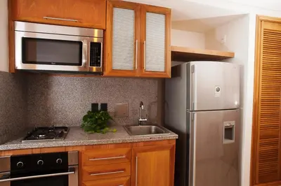 a kitchen with a stainless steel refrigerator and a sink at Hotel Irotama del Mar in Santa Marta