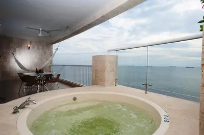 a bath tub on a balcony with a view of the ocean at Hotel Irotama del Mar in Santa Marta