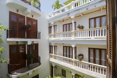 a row of apartment buildings with balconies and potted plants at Hotel Monterrey in Cartagena de Indias
