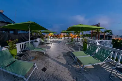 a group of chairs and umbrellas on a patio at Hotel Monterrey in Cartagena de Indias