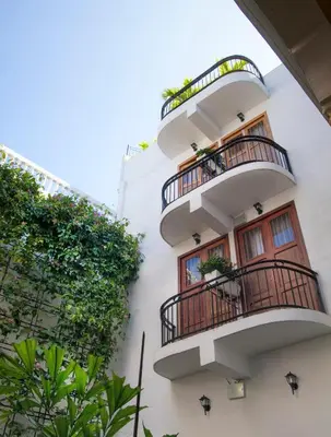 a white building with balconies and plants at Hotel Monterrey in Cartagena de Indias