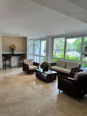 a living room with a couch and chairs and a table at Vallclaire Suites in Barranquilla