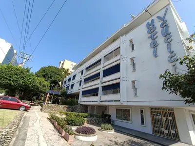 a white building with a sign on the side of it at Vallclaire Suites in Barranquilla