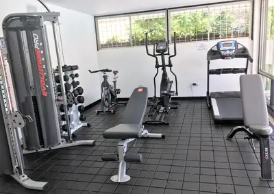 a gym with bikes and exercise equipment in a room at Vallclaire Suites in Barranquilla