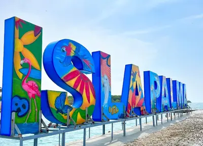 a row of colorful signs on the beach at Hotel Isla Palma Reserva Natural in Isla Palma