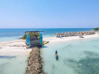 a person standing in the water on a beach at Hotel Isla Palma Reserva Natural in Isla Palma