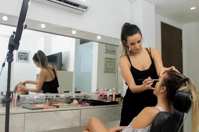 a woman brushing a girls hair in a bathroom at Hotel Casa Nico in Barranquilla