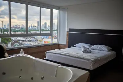 a bedroom with a bed and a bath tub at Hotel La Esperanza in Cartagena de Indias