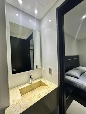 a bathroom with a sink with a mirror and a bed at Hotel La Esperanza in Cartagena de Indias