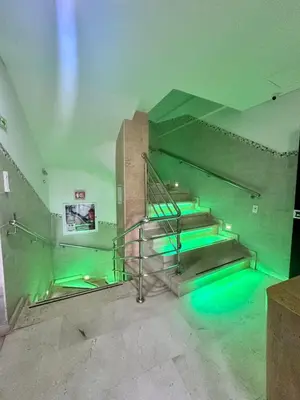 an empty room with green lights on the stairs at Hotel La Esperanza in Cartagena de Indias