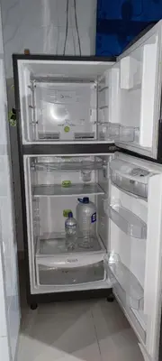 a refrigerator with its door open with a bottle of water at Posada Dakema in Cartagena de Indias