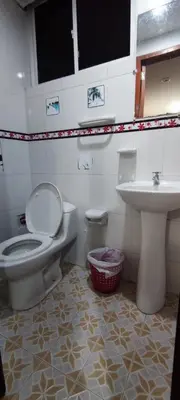a bathroom with a toilet and a sink at Posada Dakema in Cartagena de Indias