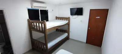 a small room with a bunk bed and a tv at Posada Dakema in Cartagena de Indias
