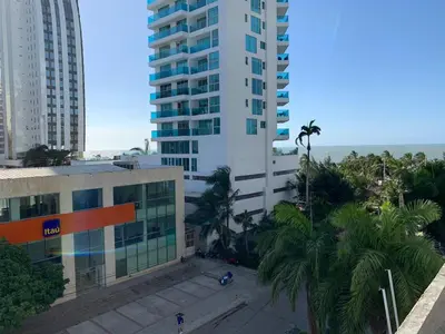 an aerial view of a building with palm trees and the ocean at Portofino Cartagena Bocagrande By ICDI in Cartagena de Indias