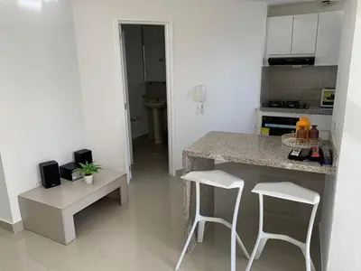 a kitchen with a counter and two white stools at Portofino Cartagena Bocagrande By ICDI in Cartagena de Indias