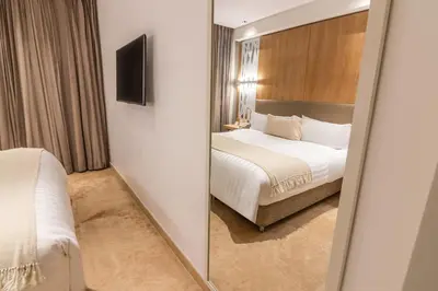 a mirror in a hotel room with a bed at GHL Arsenal Hotel in Cartagena de Indias