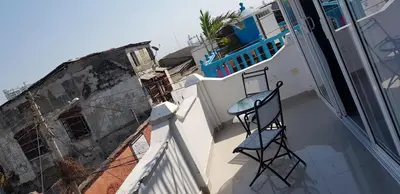 a chair sitting on the balcony of a building at Casa Evelyn in Cartagena de Indias